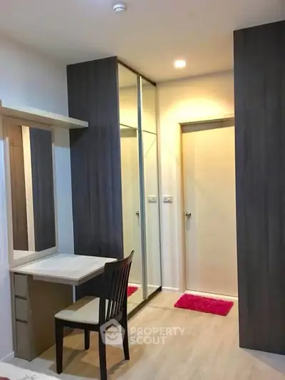 Modern bedroom with stylish furniture and mirrored wardrobe in cozy apartment