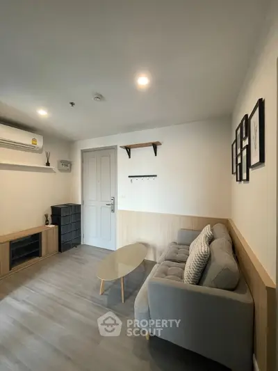 Modern living room with cozy sofa and stylish decor in a contemporary apartment.