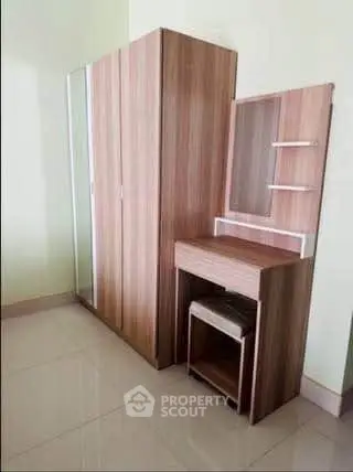 Modern bedroom with sleek wardrobe and vanity set, perfect for stylish living.