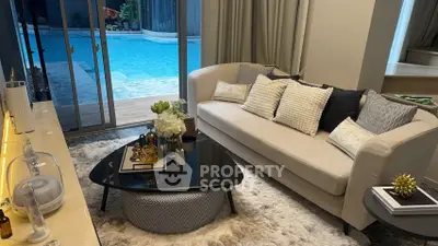 Luxurious living room with pool view, elegant decor, and cozy seating area.