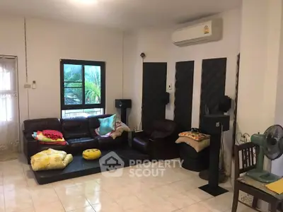 Cozy living room with air conditioning and comfortable seating, perfect for relaxation.