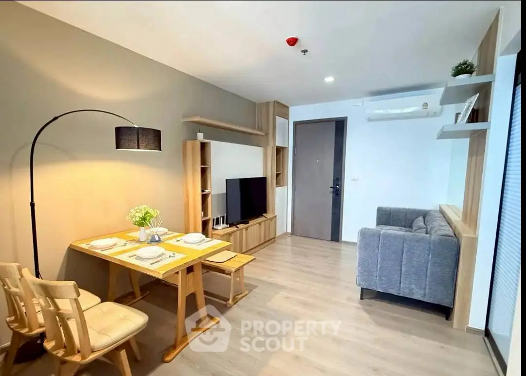 Modern living room with dining area, stylish furniture, and cozy ambiance in a contemporary apartment.