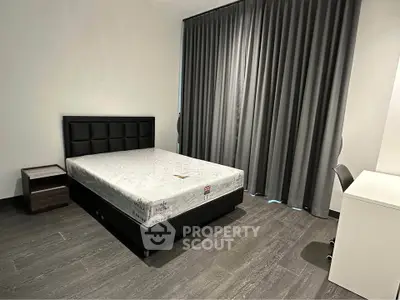 Modern minimalist bedroom with sleek design and ample natural light