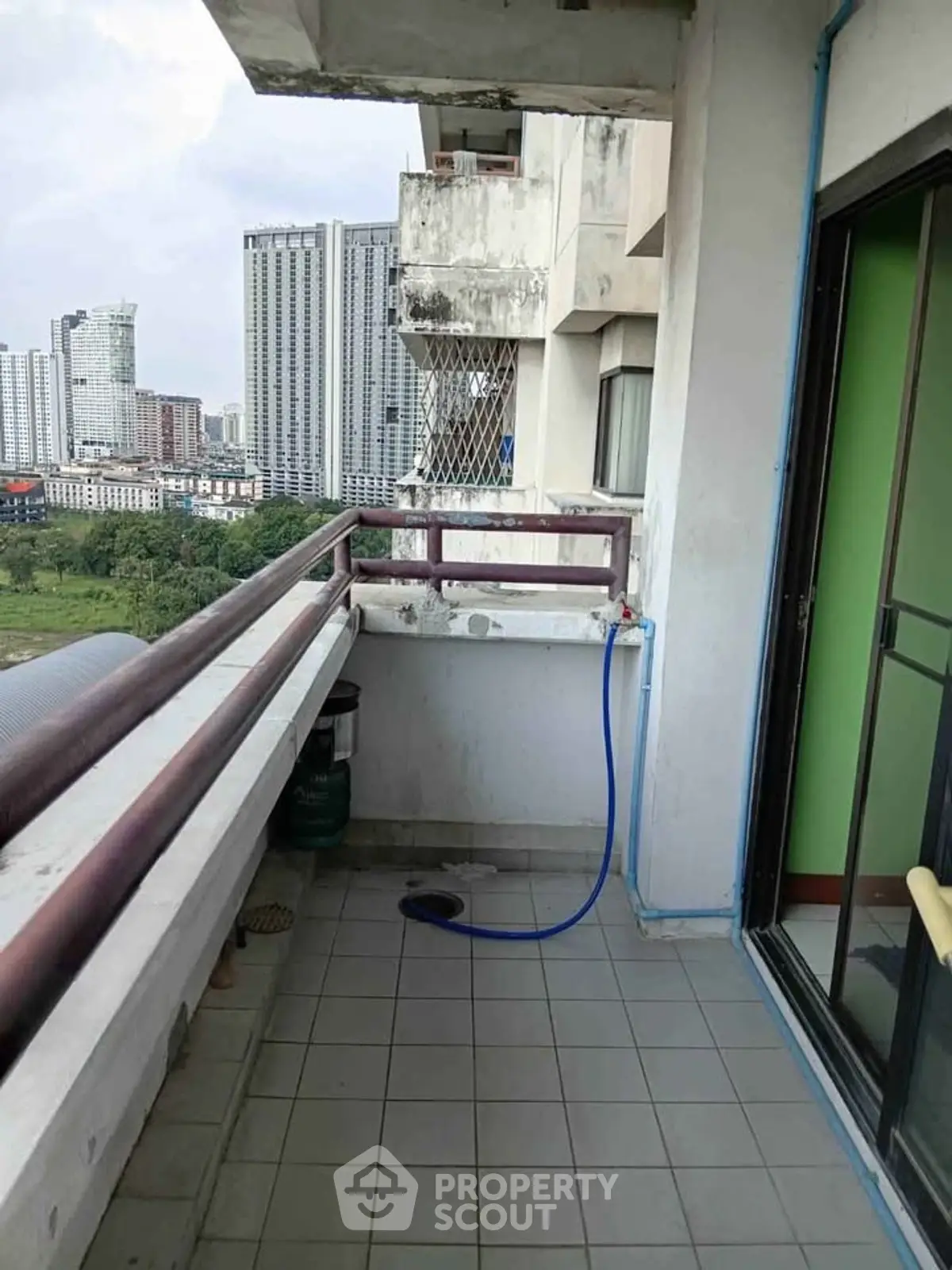 Spacious balcony with city view in high-rise apartment