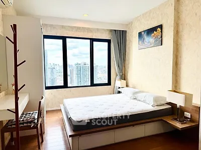 Spacious bedroom with city view and modern decor in high-rise apartment