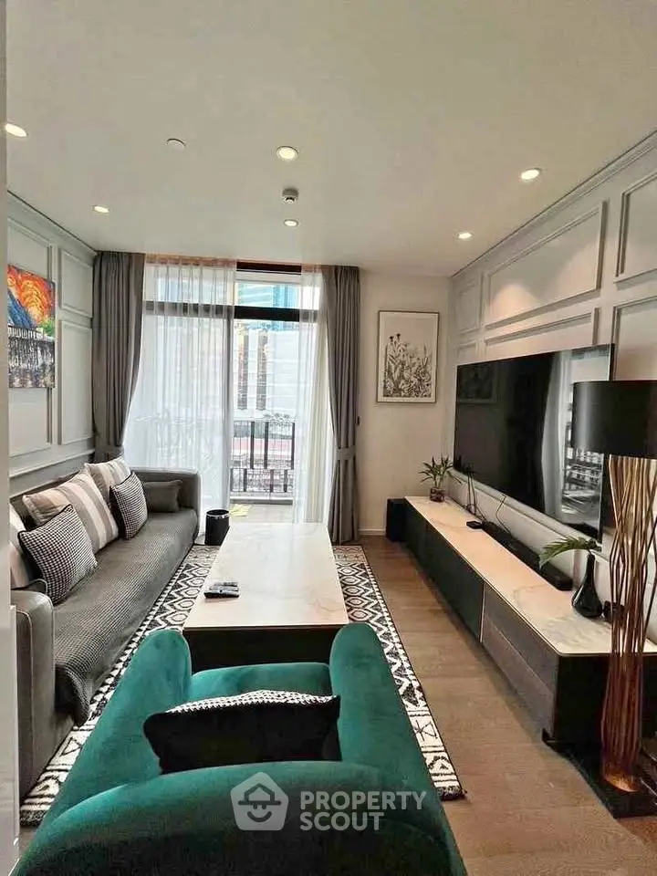 Stylish modern living room with elegant decor and large TV, perfect for relaxation and entertainment.