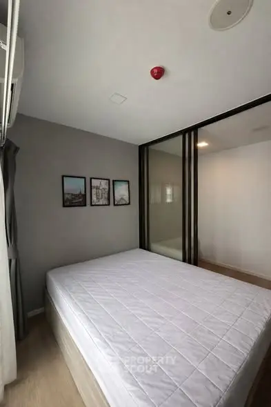 Modern bedroom with minimalist decor and large bed in a stylish apartment.