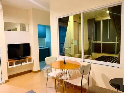Modern living room with dining area and large window in cozy apartment.