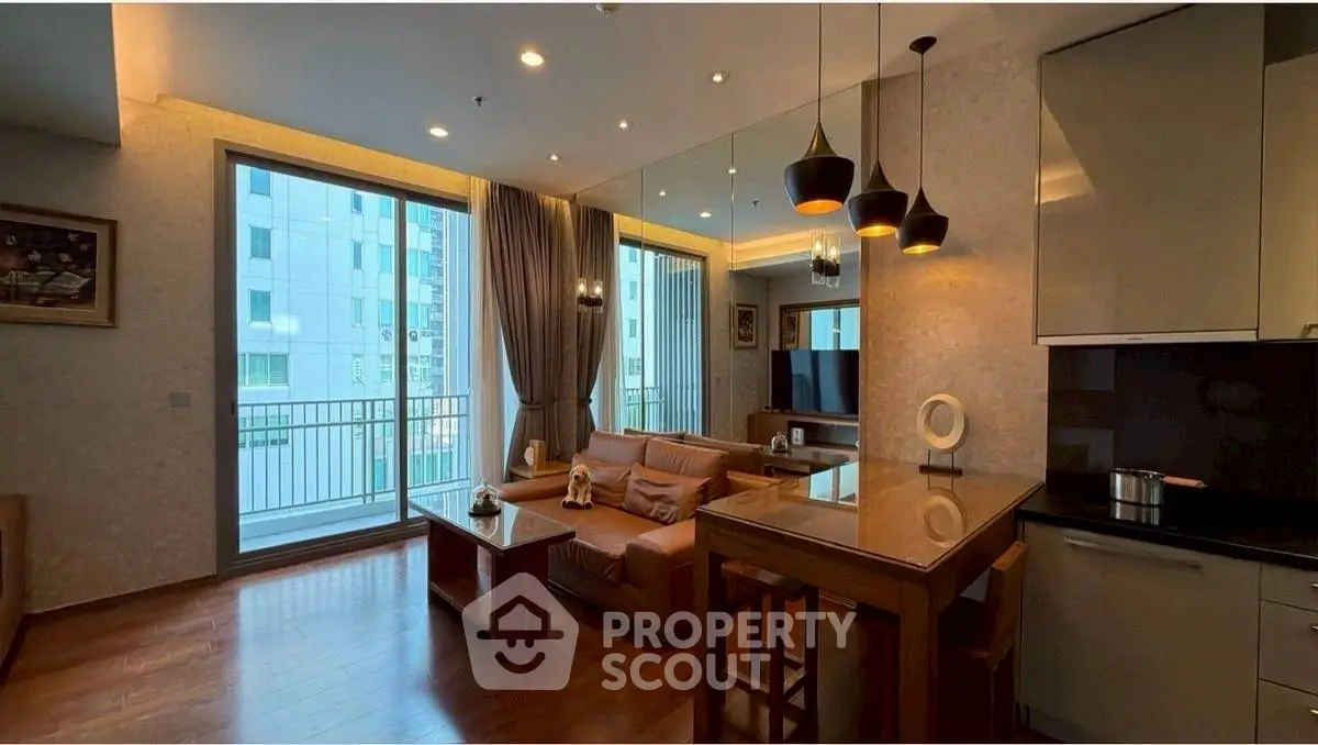 Modern living room with open kitchen and balcony view in luxury apartment