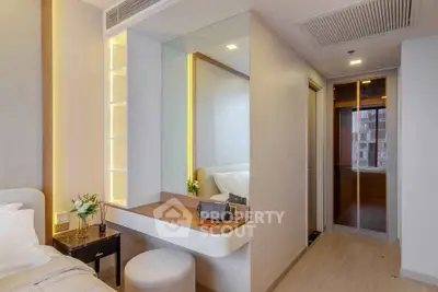 Modern bedroom with stylish vanity and elegant decor in a contemporary apartment.