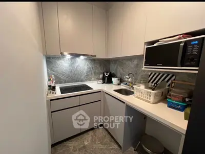 Modern kitchen with sleek cabinetry and built-in appliances