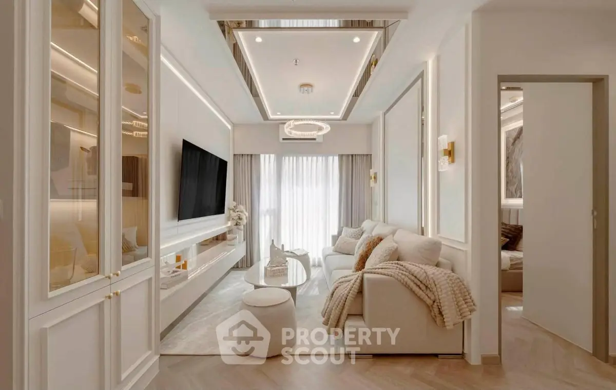 Luxurious modern living room with elegant decor and large TV, perfect for relaxation and entertainment.