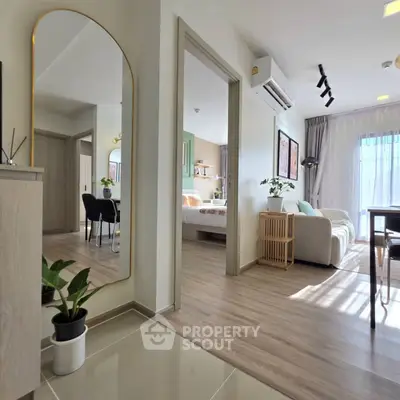 Modern apartment interior with open layout, featuring a cozy living room and stylish bedroom.