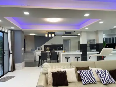 Spacious modern living room with open kitchen and stylish lighting