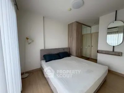 Modern bedroom with stylish decor and ample natural light