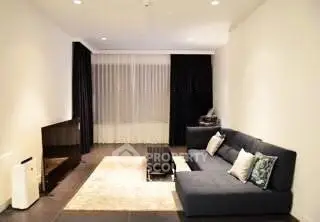 Modern living room with sleek black sofa and minimalist decor