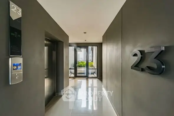 Modern apartment building entrance with sleek elevator and stylish decor