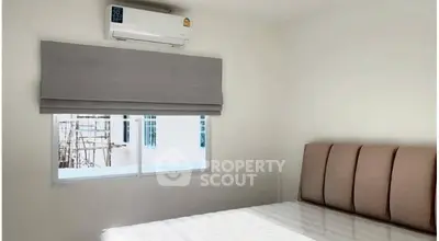Cozy bedroom with air conditioning and natural light, perfect for relaxation.