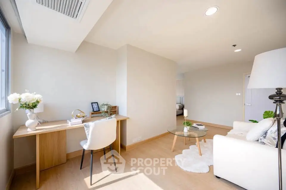 Bright and airy living room with modern decor and study area, perfect for urban living.