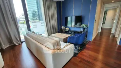 Luxurious living room with modern decor and city view, featuring elegant furniture and floor-to-ceiling windows.