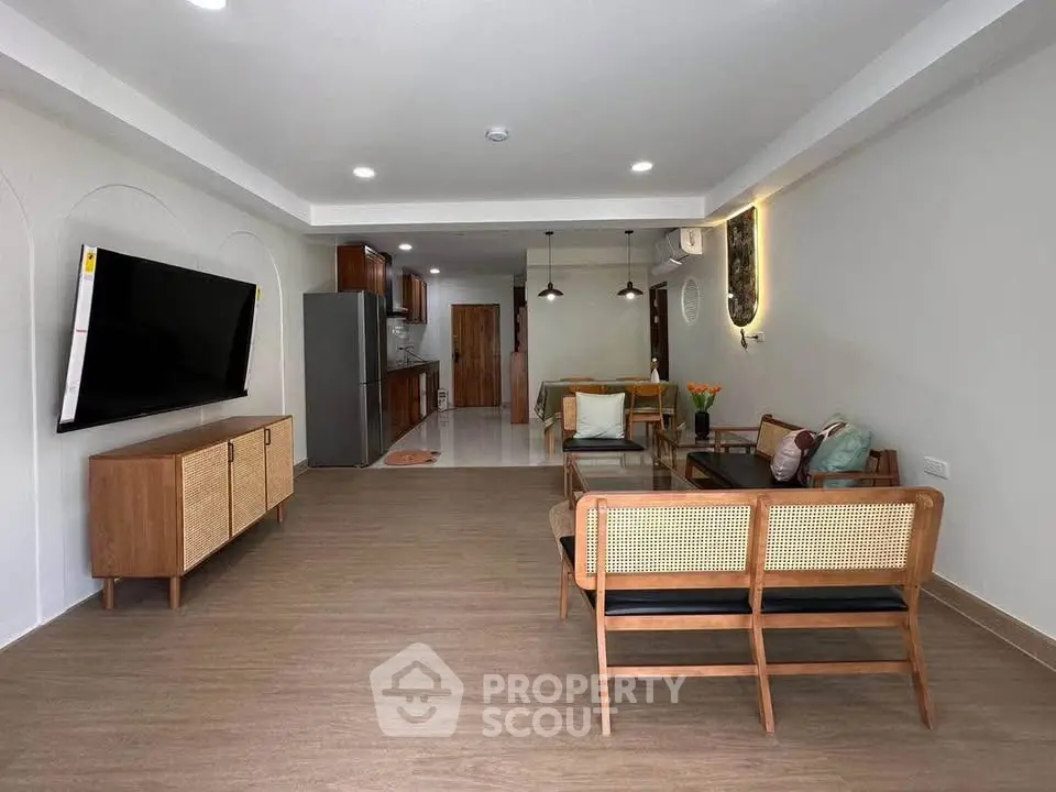 Spacious modern living room with stylish furniture and open kitchen layout
