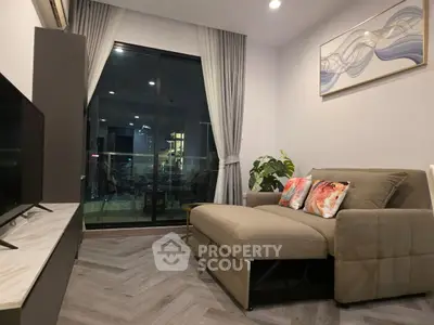 Modern living room with stylish decor and city view from large window.