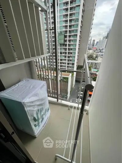 Modern apartment balcony with city view and laundry area
