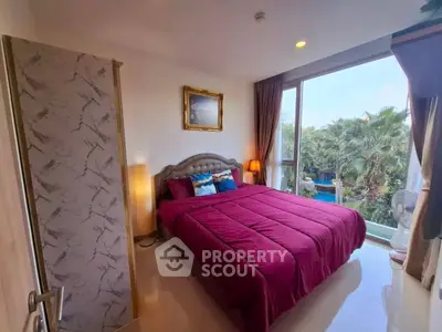 Cozy bedroom with large window and lush garden view, featuring elegant decor and vibrant bedding.