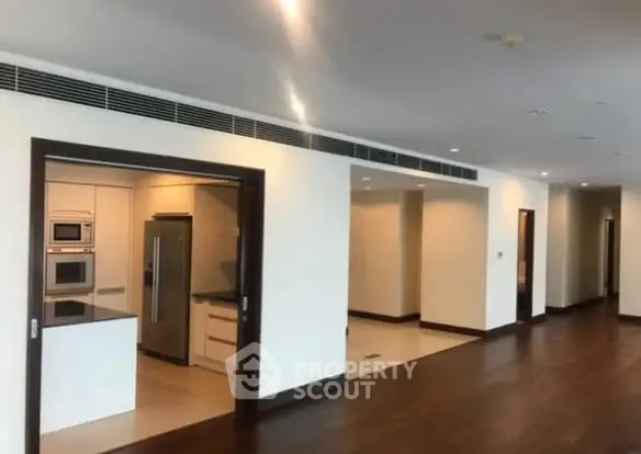 Spacious modern apartment with open layout and sleek kitchen appliances.