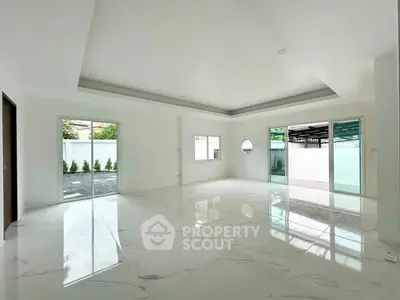 Spacious modern living room with marble flooring and large windows