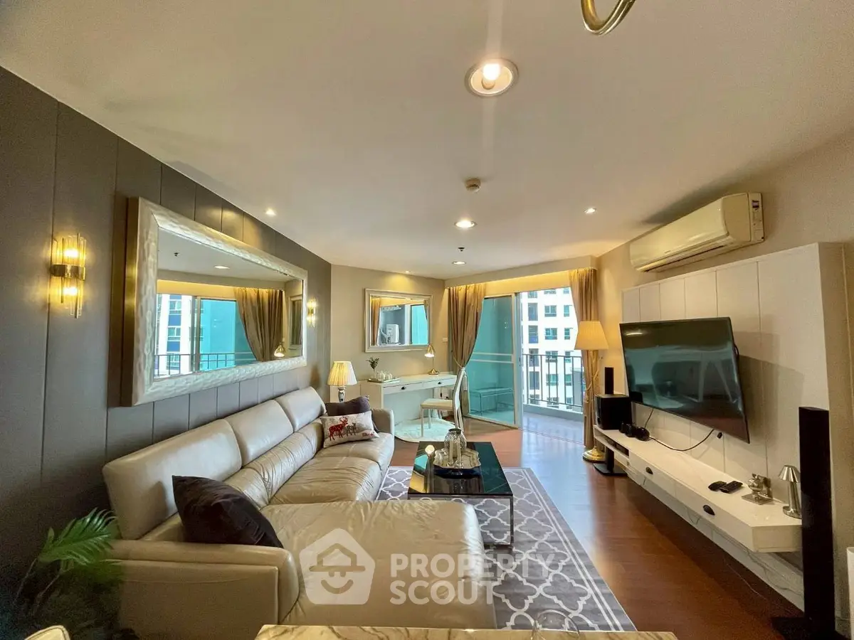 Luxurious living room with modern decor and balcony view in high-rise apartment.