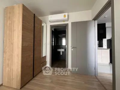 Modern apartment interior with wooden wardrobe and air conditioning