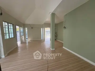 Spacious open-plan living area with large windows and modern flooring, perfect for customization.