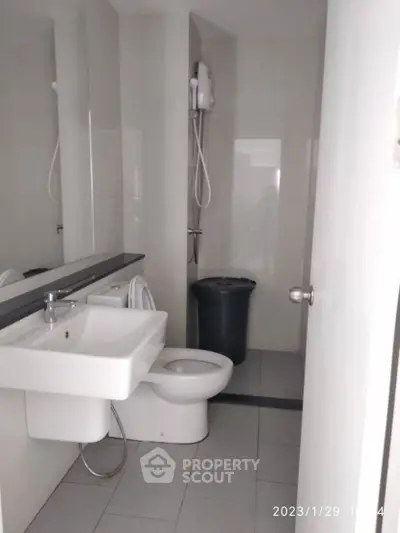 Modern bathroom with sleek fixtures and shower in a compact layout.