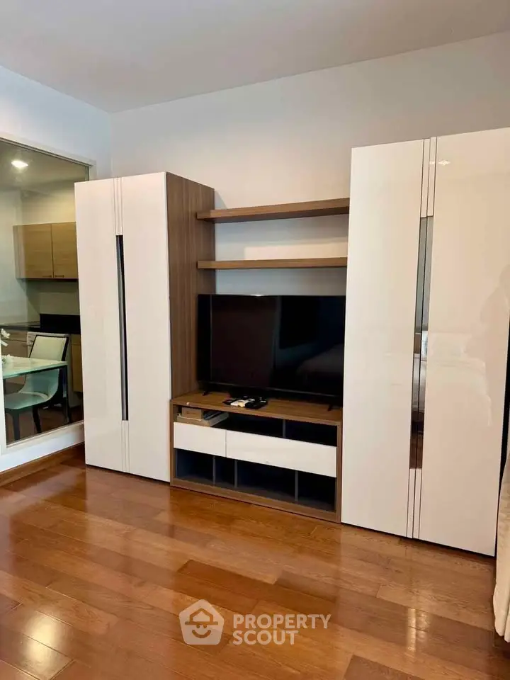 Modern living room with sleek entertainment unit and hardwood floors
