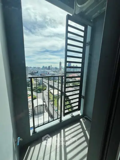 Stunning cityscape view from a modern balcony with sleek railing design.