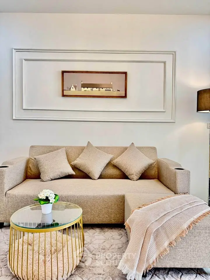 Elegant living room with beige sofa, stylish decor, and cozy ambiance perfect for relaxation.