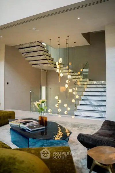 Luxurious modern living room with elegant staircase and stylish decor