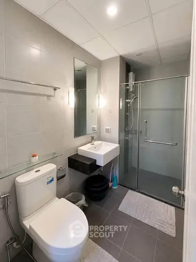 Modern bathroom with sleek fixtures and glass shower enclosure