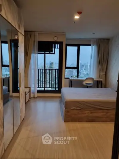 Spacious bedroom with city view and modern furnishings