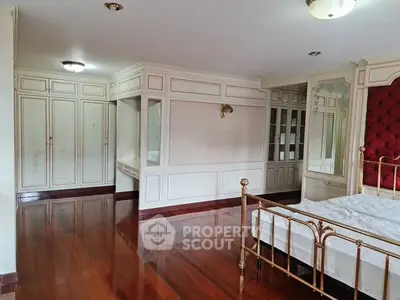 Luxurious bedroom with elegant wooden flooring and classic decor