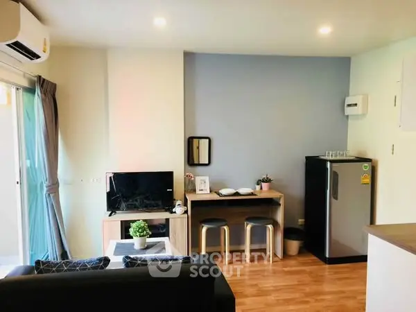 Modern living room with compact dining area and sleek appliances
