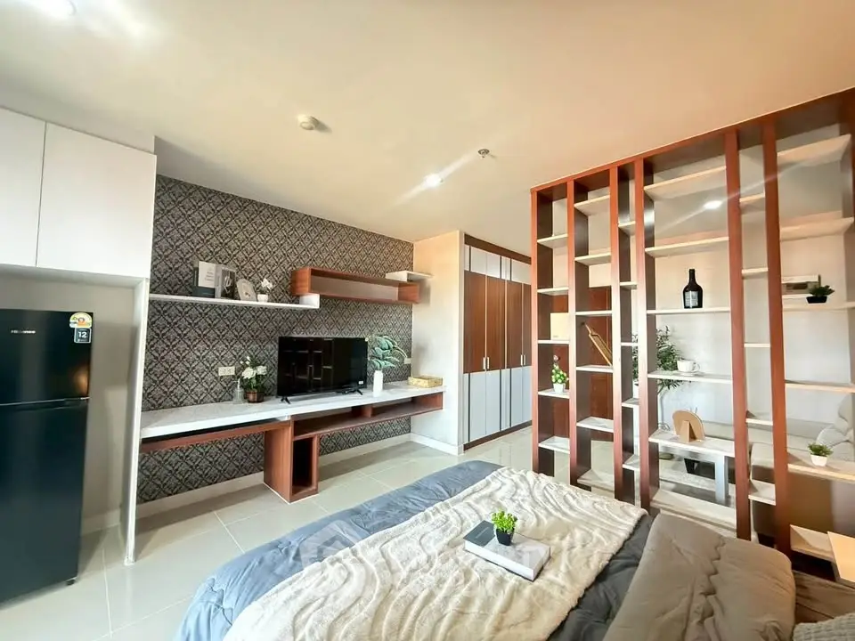 Modern studio apartment with stylish shelving and cozy decor