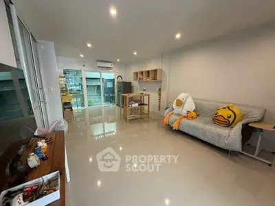 Spacious living room with modern decor and large windows for natural light.