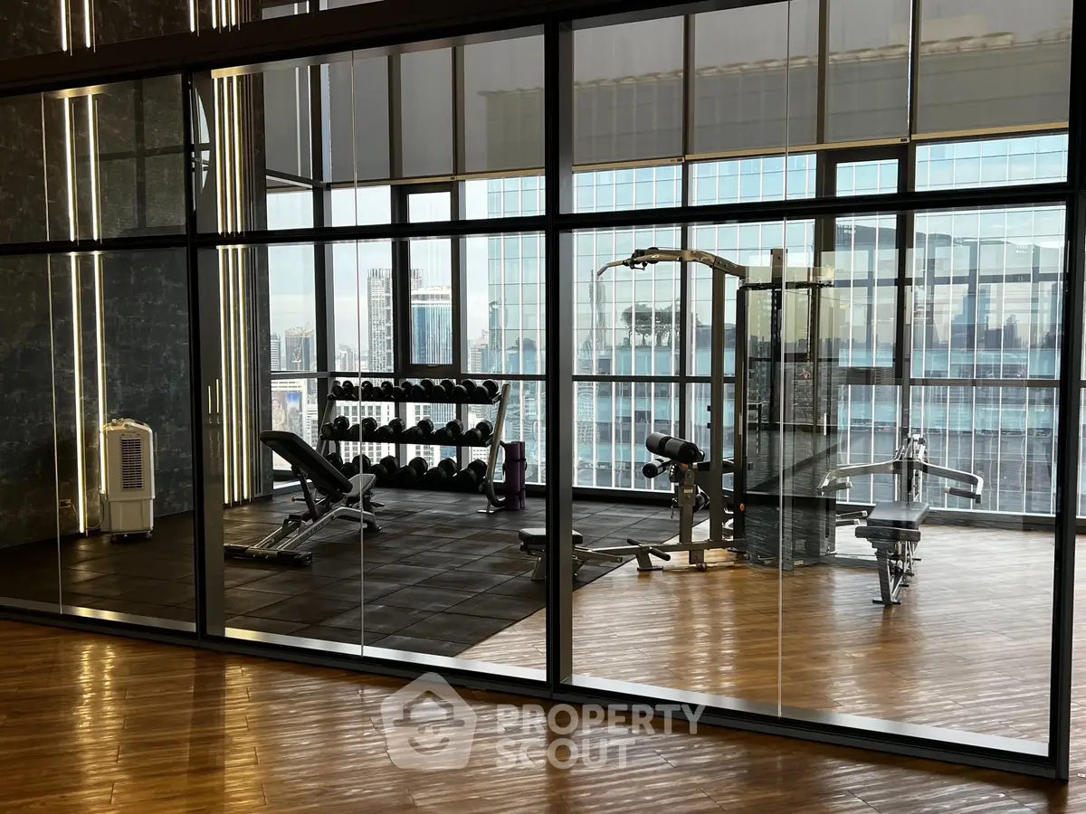 Modern gym with city view, featuring state-of-the-art equipment and sleek design.