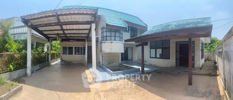 Spacious two-story house with unique architectural design and ample outdoor space.