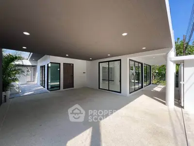 Modern home exterior with spacious covered patio and large glass doors