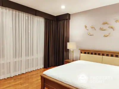 Elegant bedroom with polished hardwood floors, contemporary decor, and layered curtain design for adjustable lighting.