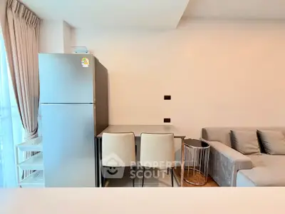 Modern living room with sleek fridge and cozy seating area