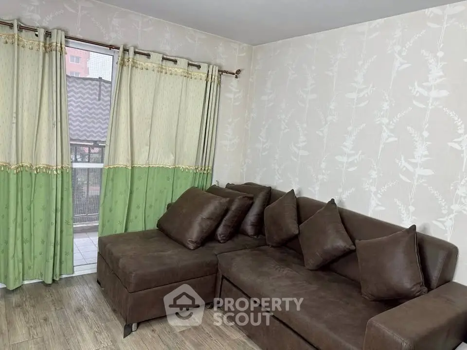 Cozy living room with brown sectional sofa and balcony view